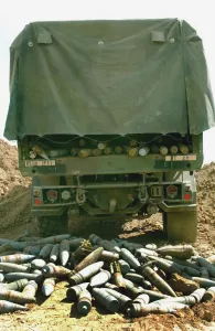 The ammunition cache unloaded in a crater for preparation for destruction The ammunition cache unloaded in a crater for preparation for destruction