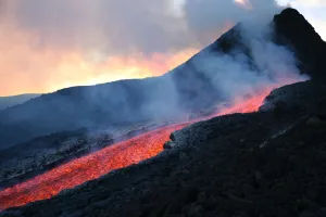 Lava flowing from base of hornito during eruption of Mount Etna volcano, Sicily, Italy Lava flowing from base of hornito during eruption of Mount Etna volcano, Sicily, Italy