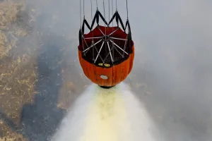 Water drops are performed using Bambi Buckets to assist the wildfires in California Water drops are performed using Bambi Buckets to assist the wildfires in California